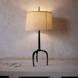 Handcrafted lamp with a bronze base and refined linen shade. Combines artisanal craftsmanship with contemporary design. Perfect for any decor.