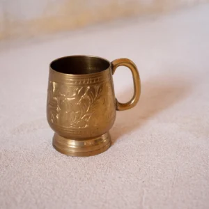 Discover the cutest hand-carved brass cup from India. Perfect for adding a touch of charm to any space. Order now for a unique decor piece.