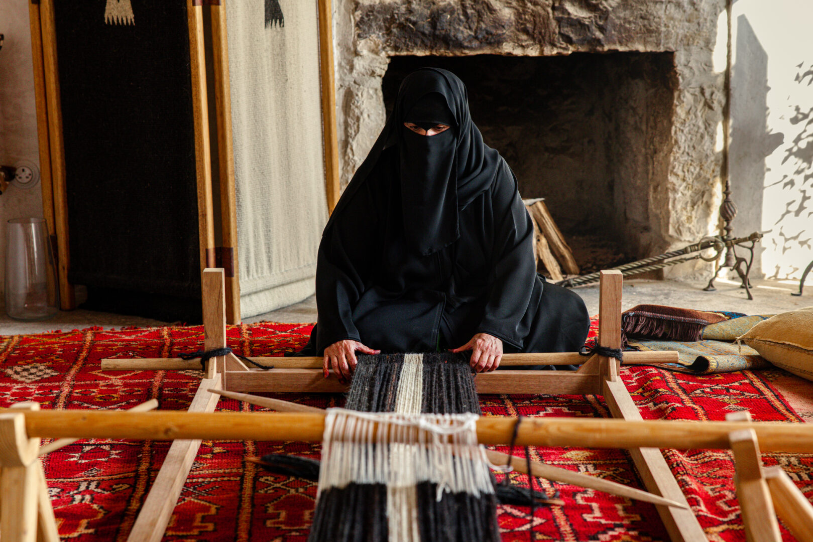 Weaving on a traditional ground loom at Heenat Salma Farm