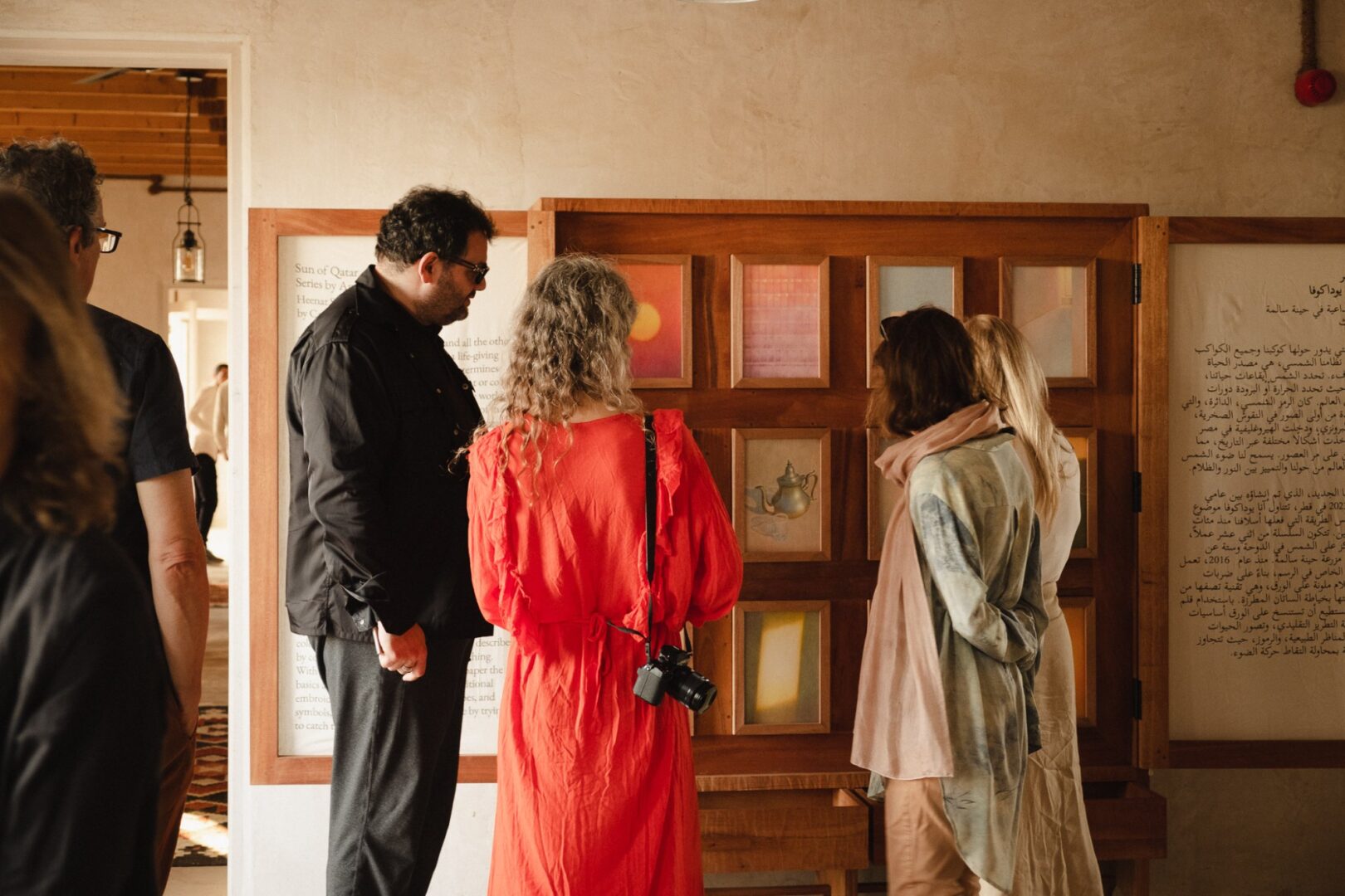Visitors looking at artworks displayed on a gallery wall