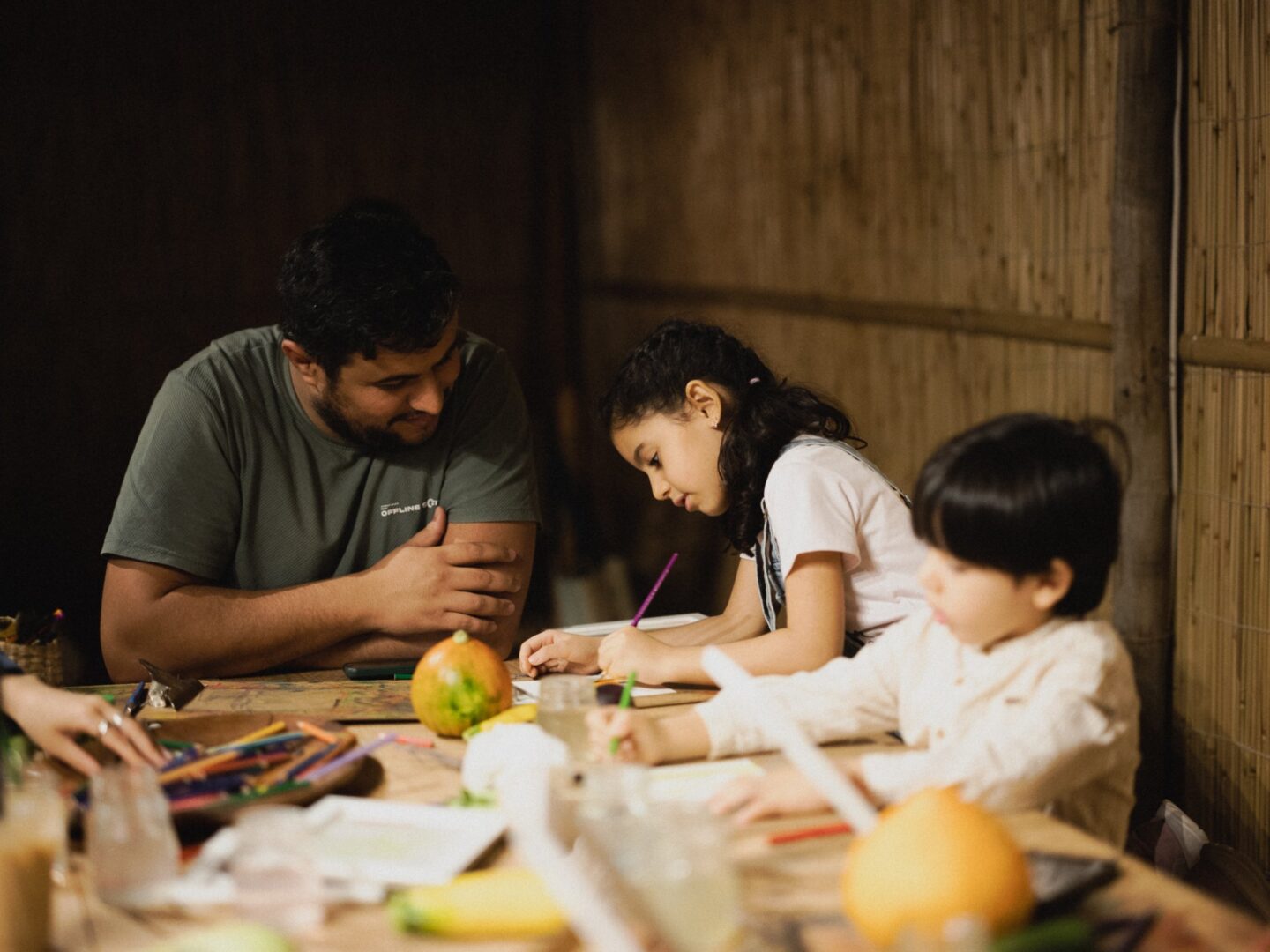 A family painting together at a workshop table